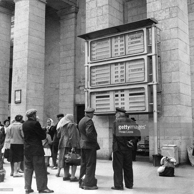 A group of travelers look at an automated railway timetable at Kharkov railway station in USSR (January 01, 1960).jpg