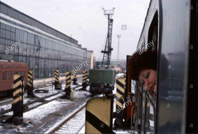 Woman looks out of Window as the train’s gauge is changed going from Poland into Russia at Brest Station in Belarus.jpg