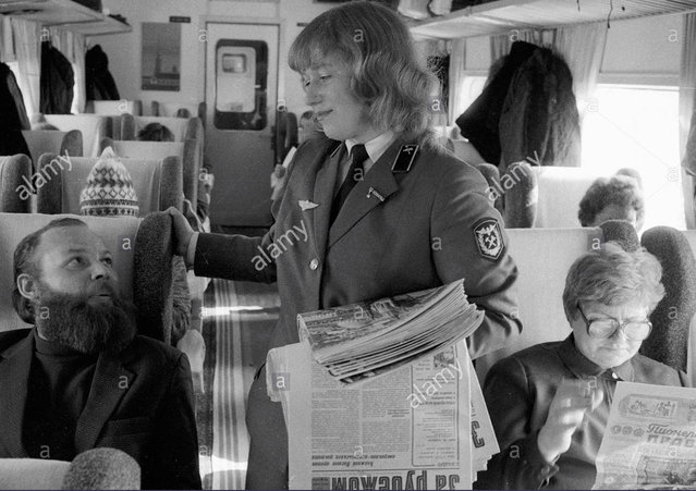 Stock Photo - Conductor offering passengers newspapers ER200 Moscow - Leningrad speed train.jpg